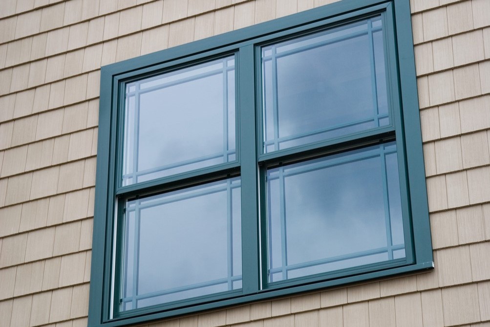 Image of green painted window with prairie grids