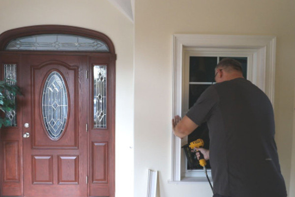 man installing window