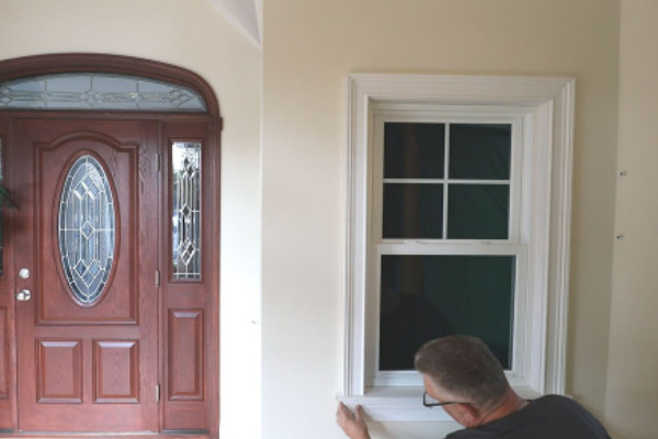 man installing window