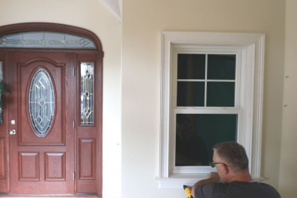 man installing window