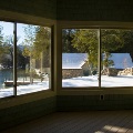 interior of home with large rolling windows overlooking lake