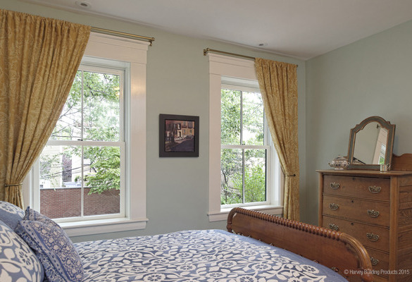 interior of bedroom with two double hung windows