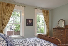 interior of bedroom with two double hung windows