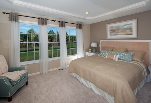 interior of bedroom with three double hung windows